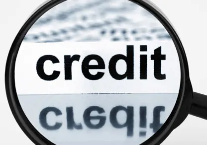 A magnifying glass held over the word credit
